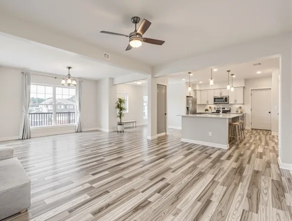 Portfolio-Wide Turn Program — UTS BuildPros unit turn renovation Completed living room unit turn — fresh paint, LVP flooring, modern lighting in Houston apartment