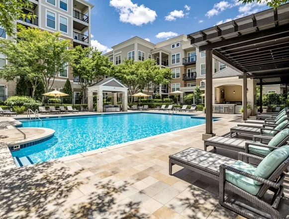 Resort-style pool deck renovation — travertine decking and cabanas in Fort Worth apartment community